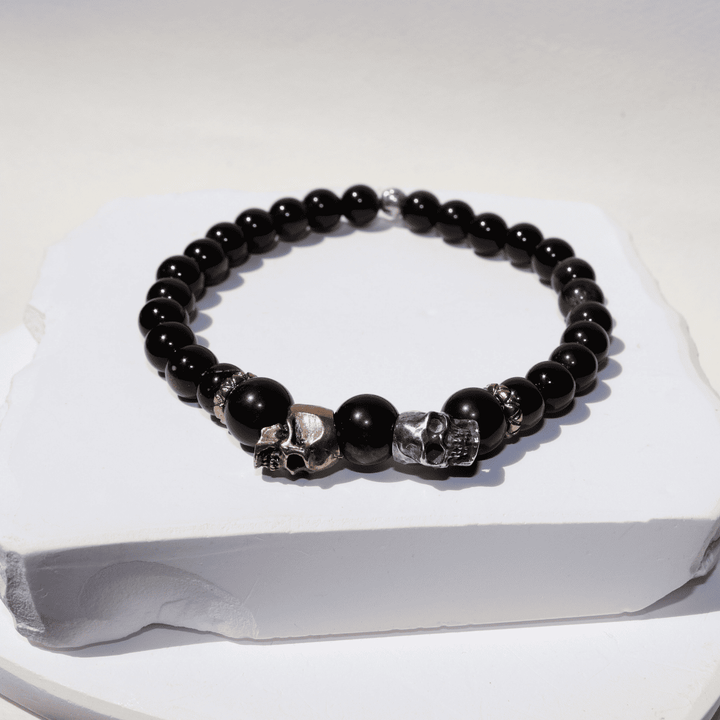 Kuro obsidian bead bracelet with 925 silver and bronze skulls